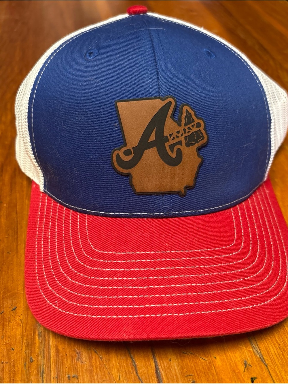 Blue and Red Trucker Hat with Brown Patch Logo